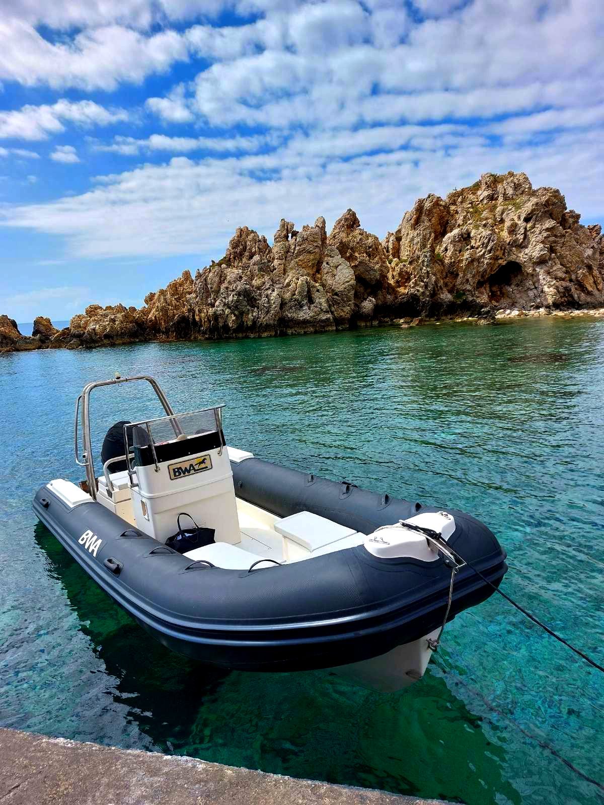 Eleni speed boat on calm turquoise water near the coast of Paros