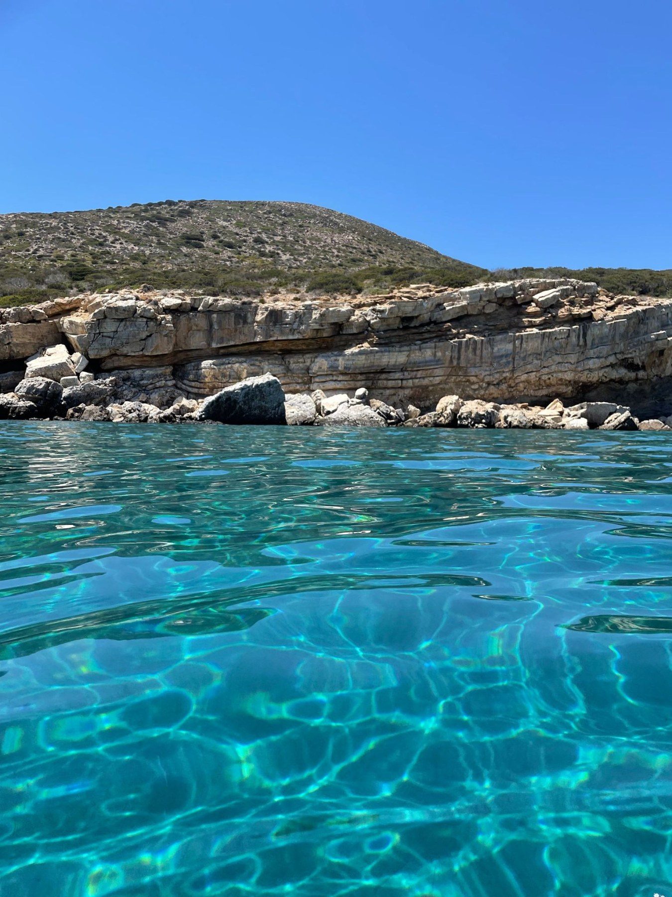 Shallow clear water along the rocky coast of Paros